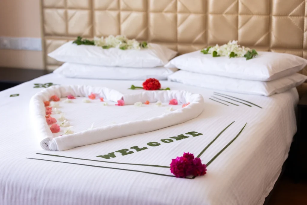 Guest room with decorative welcome arrangement at Abuharee Grand